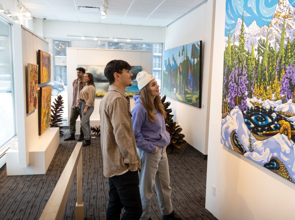 Friends explore the Canada House Gallery on Bear Street in the Banff Townsite.